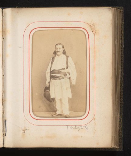 Portrait of a man in Romanian traditional dress with a hat in his hand