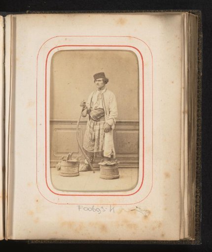 Portrait of a man in Romanian traditional dress with a yoke and wooden buckets