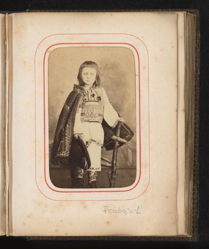 Portrait of a boy in Romanian traditional dress with a cape