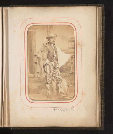 Portrait of a man dressed as a rider in Romanian costume with whip in hand