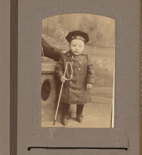 Portrait of a boy with hat and cane
