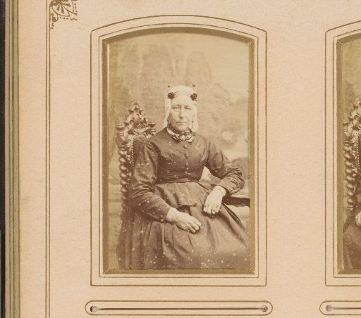 Portrait of a Seated Woman with a Traditional Cap and Ear Ornaments