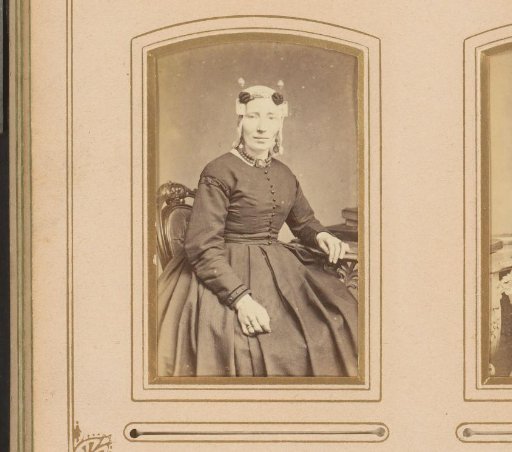 Portrait of a seated woman with a cap and ear-rings