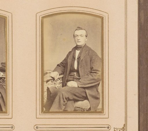 Portrait of a man, seated at a table