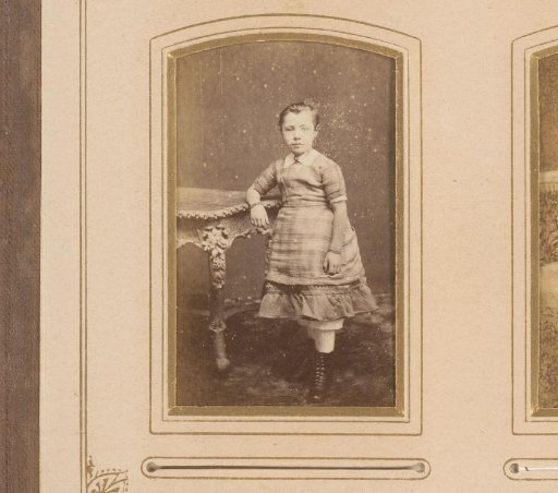 Portrait of a girl, standing by a table