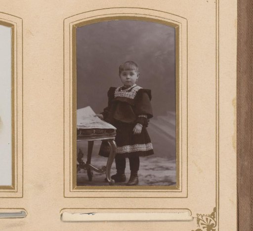 Portrait of a girl, standing by a stool