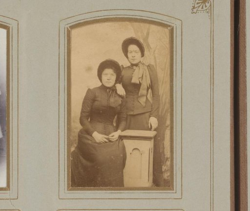 Portrait of two young women by a column
