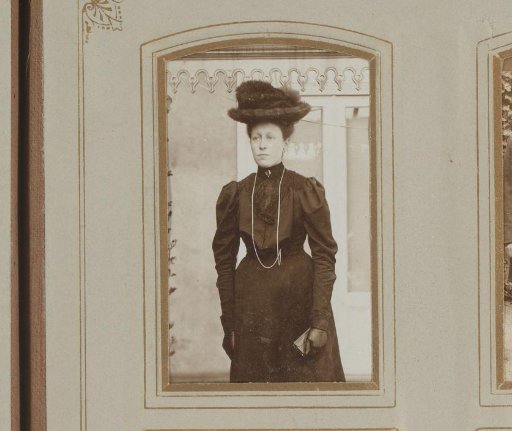 Portrait of a woman in a black dress with a hat