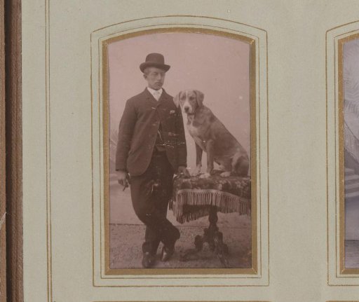Portrait of a young man at a table with a dog