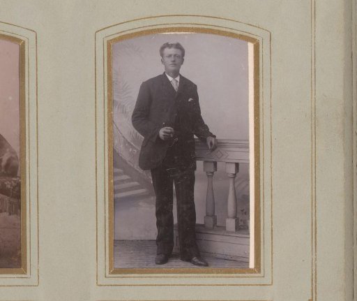 Portrait of a man standing by a balustrade
