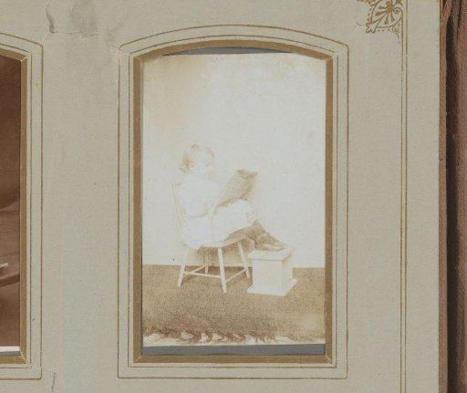 Portrait of a girl in a chair, with her feet on a stove
