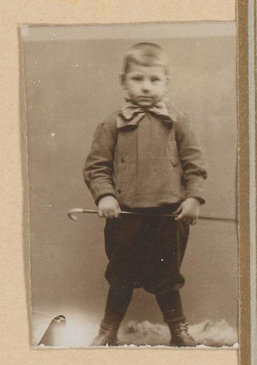 Portrait of a Boy Holding a Walking Stick