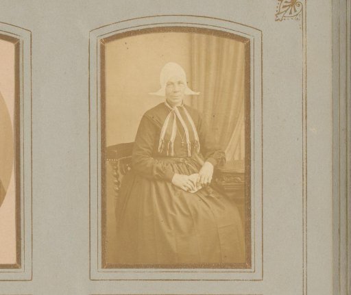 Portrait of a Seated Woman in a Traditional Cap with Ear-Flaps
