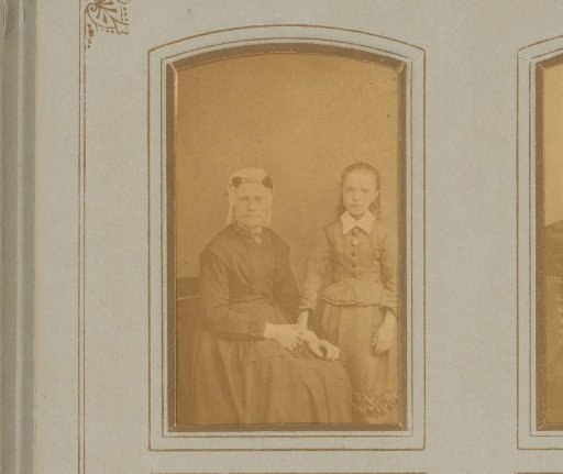 Portrait of a Seated Woman in a Traditional Cap with Ear-Flaps and a Standing Girl