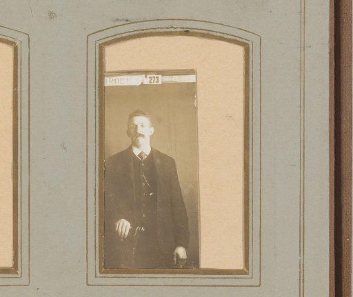 Portrait of a man standing by a chair