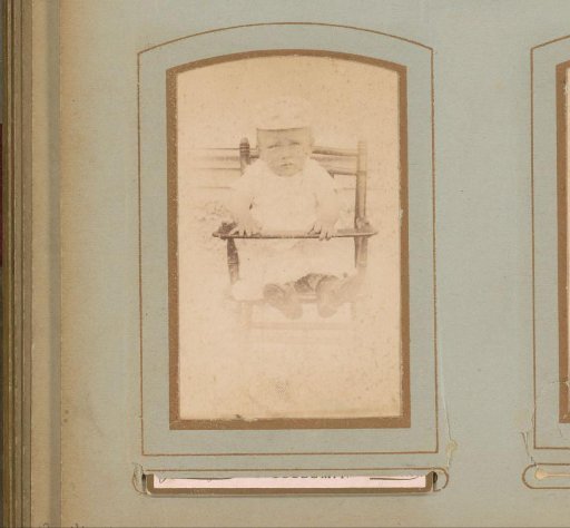 Portrait of a child, seated in a high chair
