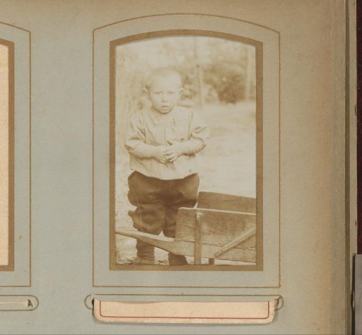 Portrait of a child with a wheelbarrow