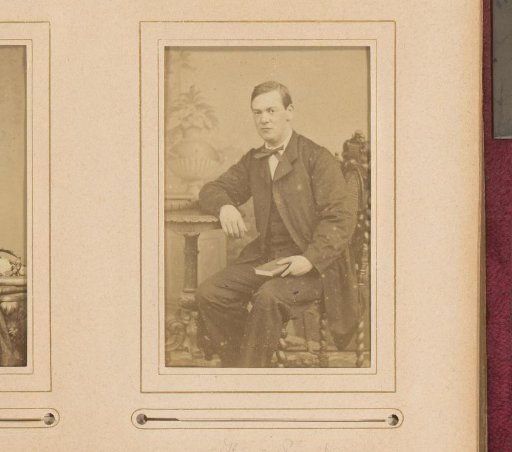 Portrait of a seated man with book