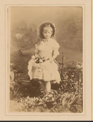 Portrait of a girl with hat and flower basket