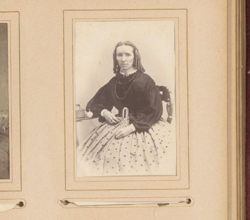 Portrait of a Woman with Ringlets by a Table with a Perfume Bottle