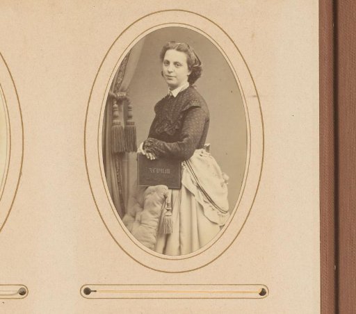 Portrait of a Standing Woman with a Photo Album
