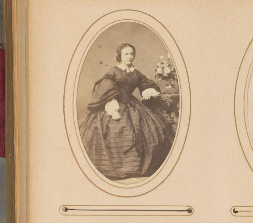 Portrait of a Seated Woman at a Table with a Flower Piece