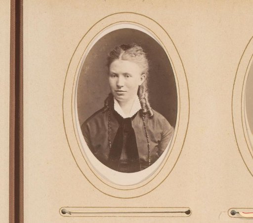 Portrait of a young woman with bow and necklace