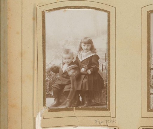 Portrait of a boy and girl in sailor suits with a hoop