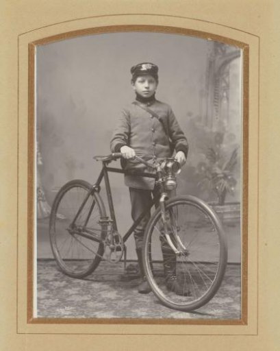 Portrait of a boy with a cap and bicycle