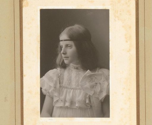 Portrait of a girl in a white striped dress with headband