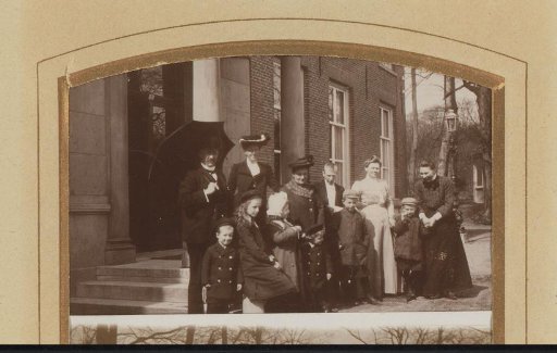Group portrait of a family in front of a house