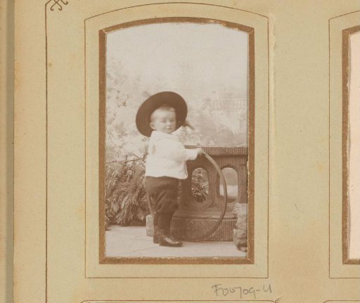 Portrait of a boy with a large hat and hoop