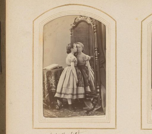 Girl in front of the mirror with an open photo album