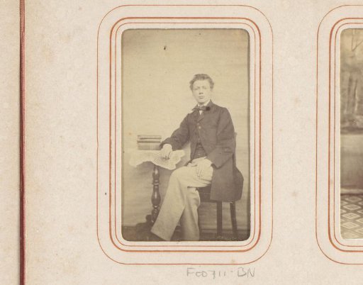 Portrait of a Seated Young Man at a Table with Books