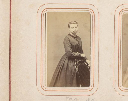 Portrait of a standing woman by a chair