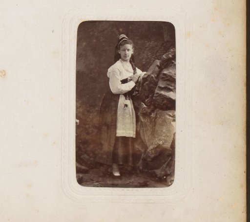 Portrait of a girl standing by a rock wall