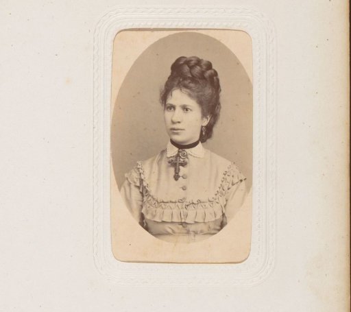 Portrait of a woman with a necklace featuring a cross