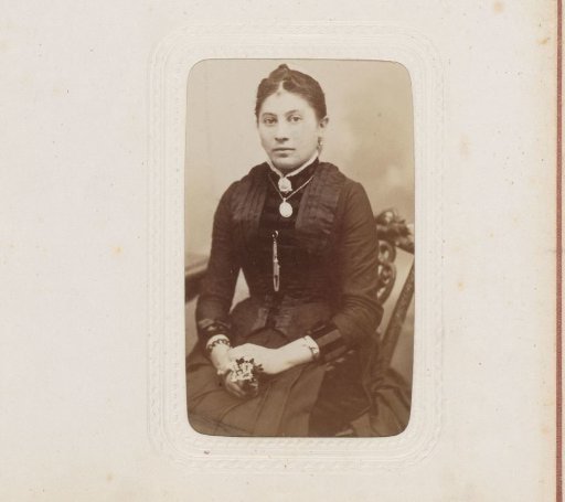 Portrait of a woman with a necklace, seated on a chair