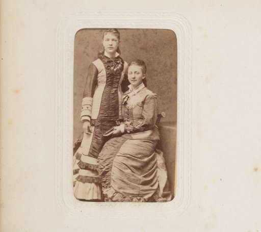 Portrait of two young women, one seated on a chair