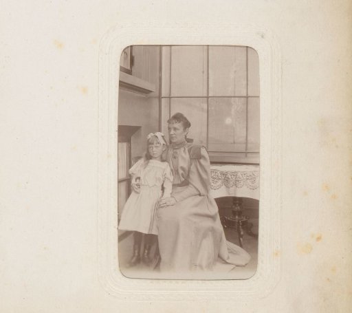 Portrait of a seated woman and a standing girl in an interior