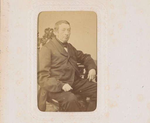 Portrait of a man, seated at a table