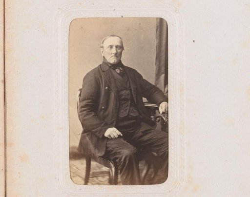 Portrait of a man, seated at a table