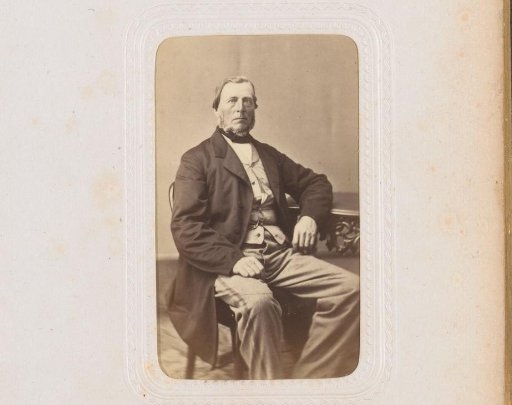 Portrait of a man, seated at a table