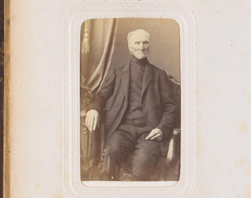 Portrait of a man, seated at a table