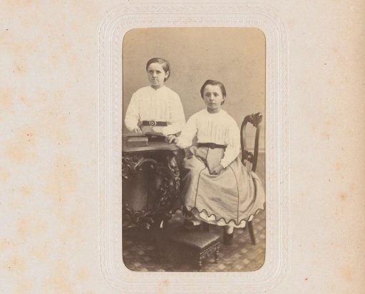 Portrait of two girls at a table with books