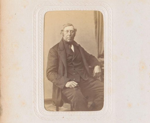 Portrait of a man, seated at a table