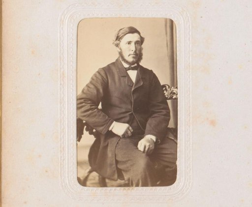 Portrait of a man, seated at a table