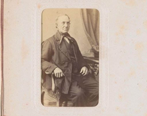 Portrait of a man, seated at a table