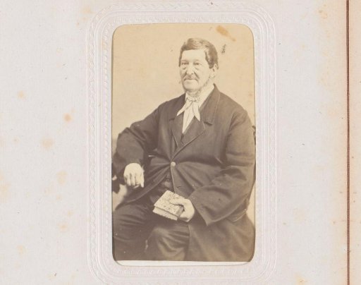 Portrait of a seated man holding a book, inscribed as De Kleyn