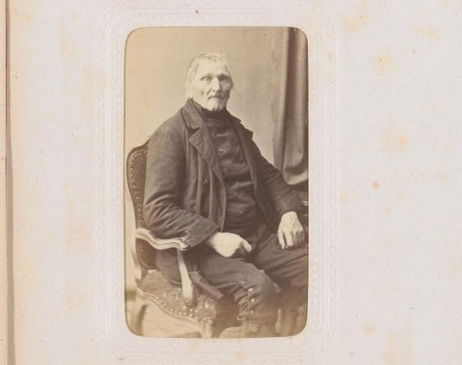 Portrait of a man, seated at a table